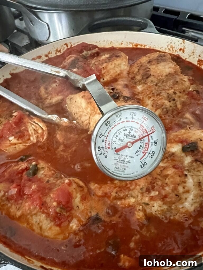 One-Pan Chicken Pomodoro Recipe for Quick Weeknight Dinners 15 Checking the internal temperature of the chicken with a stem thermometer.