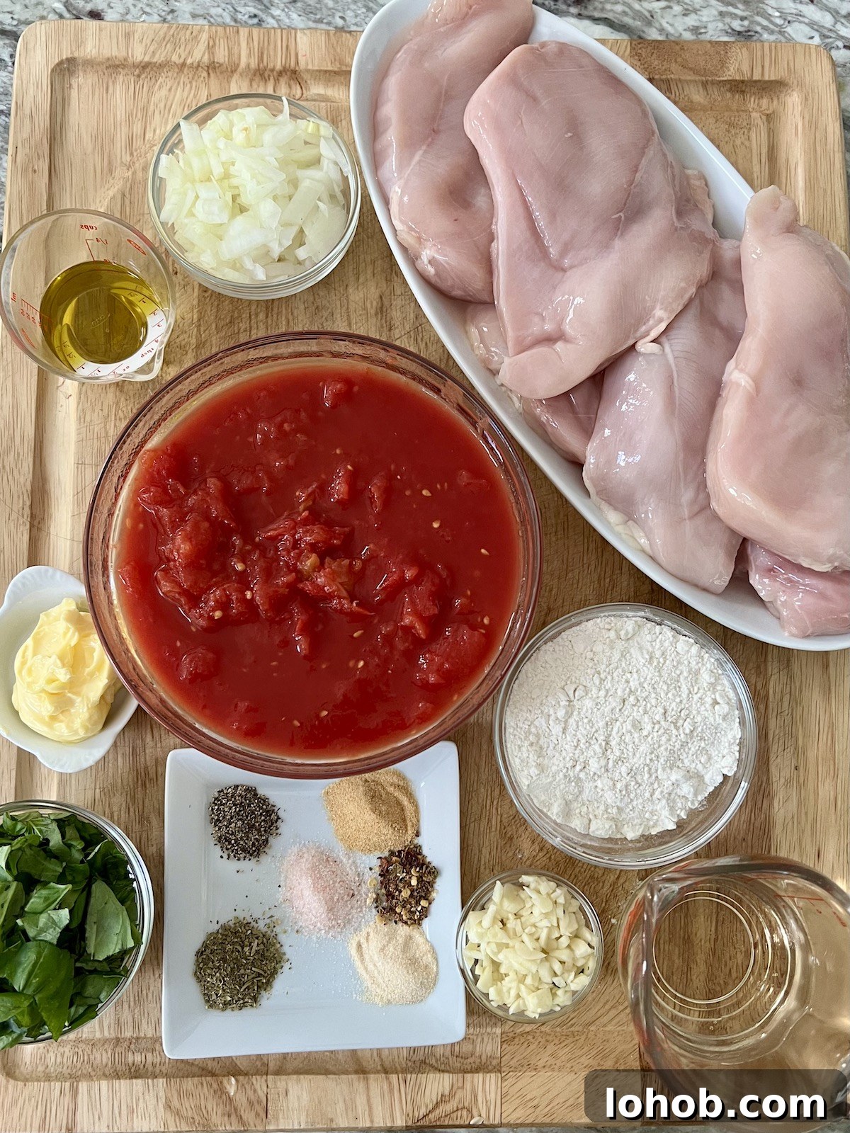 One-Pan Chicken Pomodoro Recipe for Quick Weeknight Dinners 5 All prepped ingredients for One Pan Chicken Pomodoro recipe on cutting board.