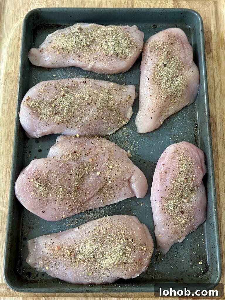 One-Pan Chicken Pomodoro Recipe for Quick Weeknight Dinners 7 Chicken breasts sprinkled with salt and pepper on baking sheet.