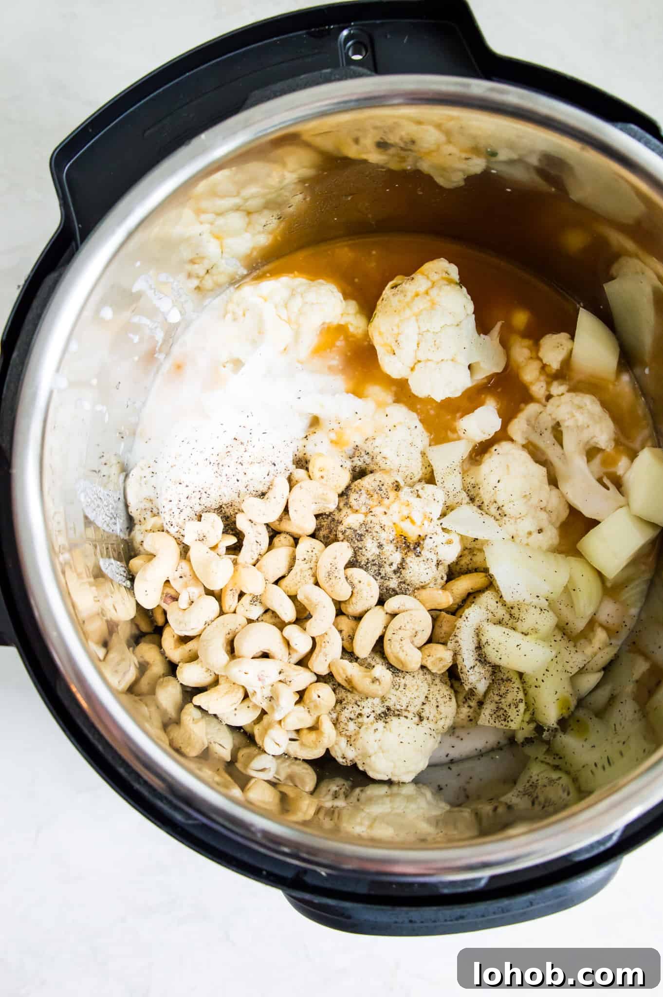 Instant Pot Creamy Cauliflower Soup — Vegan & Low-Calorie 4 An instant pot filled with cauliflower florets, broth, cashews and coconut milk.