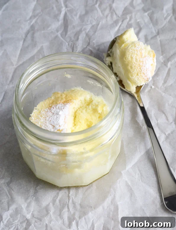 Yellow cake in a jar and on a spoon, both on white paper