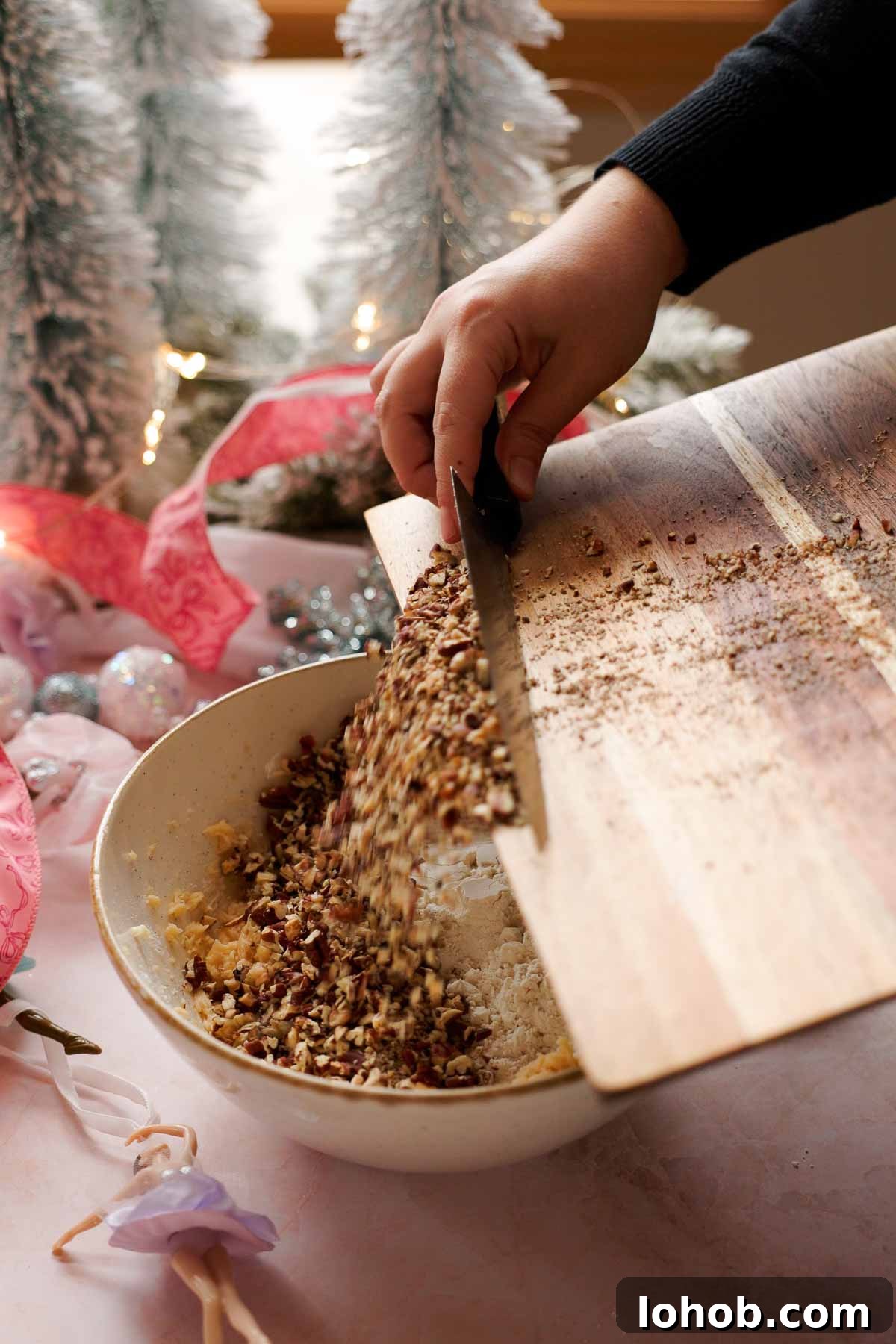 adding chopped toasted pecans into cookie dough
