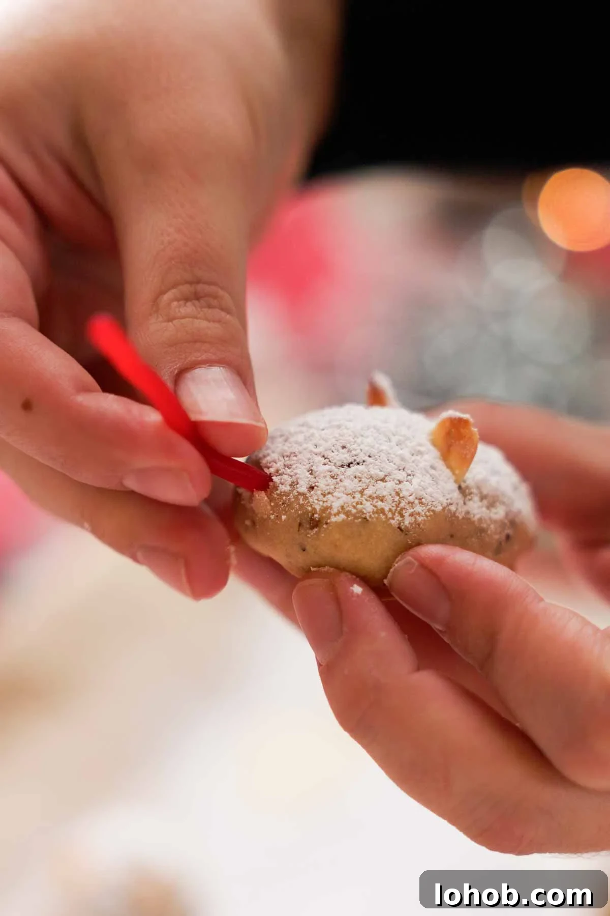adding candy tails onto mouse cookies