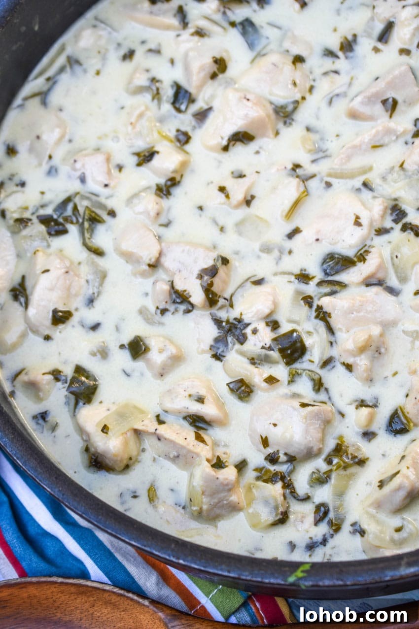 CREAMY POBLANO CHICKEN IN A LARGE BLACK SKILLET
