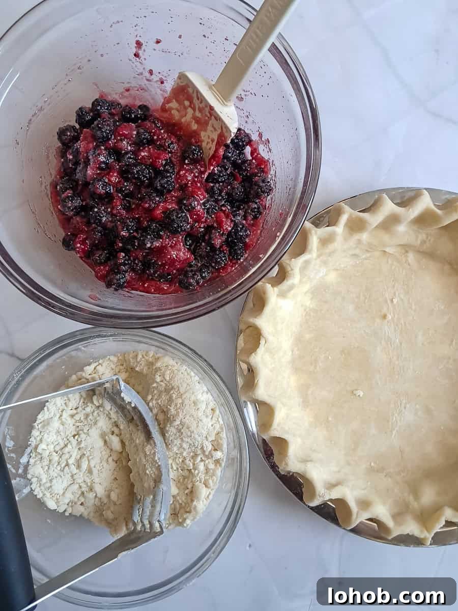 9" pie crust, a bowl with the fruit filling, and a bowl with the crumb topping.