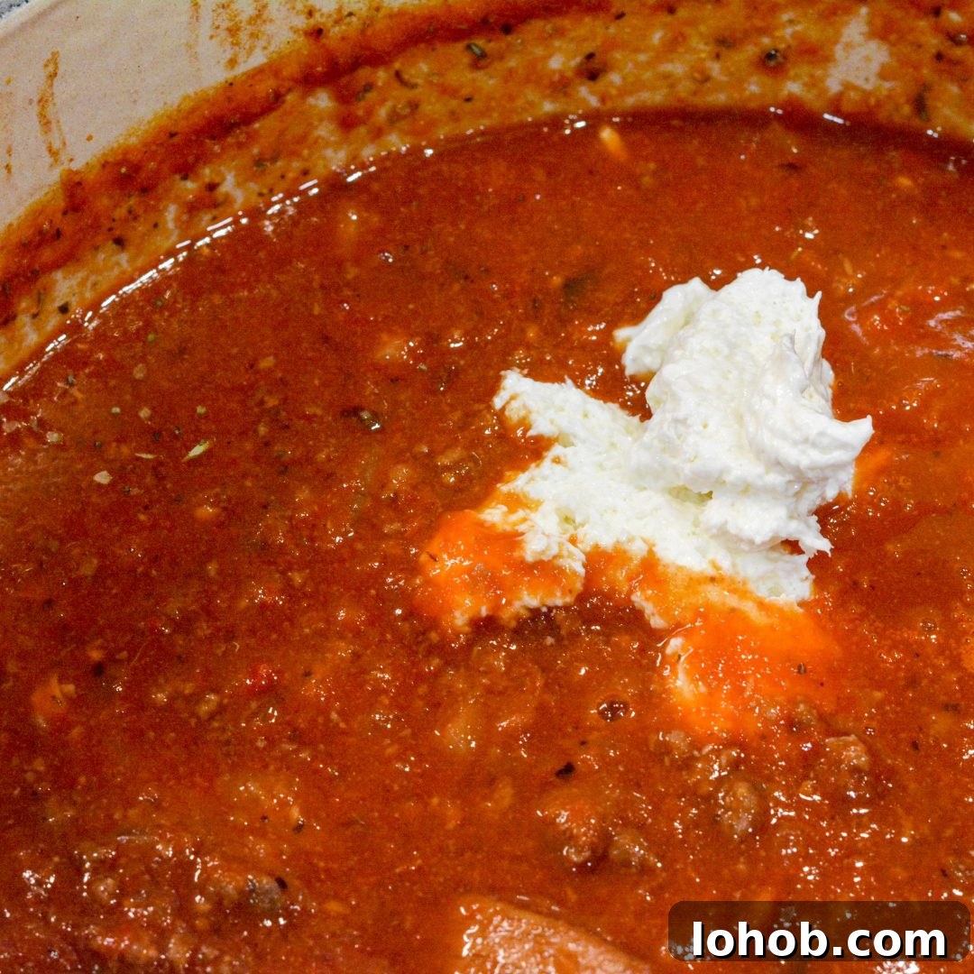 Homemade SpaghettiOs Recipe: Classic Kid-Friendly Pasta in Minutes 7 Next, stir in the cream cheese and two cups of water. Let the mixture begin to boil.
