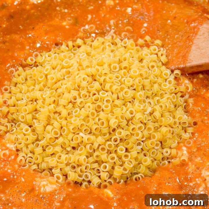 Homemade SpaghettiOs Recipe: Classic Kid-Friendly Pasta in Minutes 8 Finally, add the pasta rings and stir to combine, then reduce to a simmer and place the lid on the pot. Simmer for 15-20 minutes or until pasta is soft.