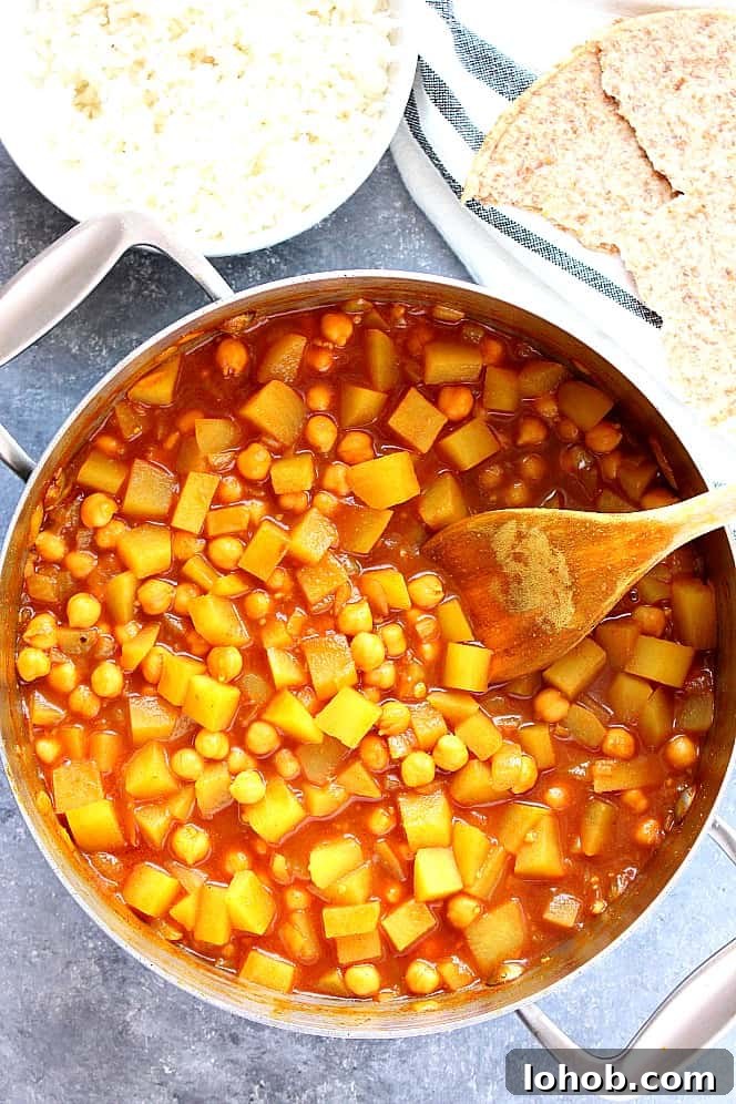 curry with potatoes and chickpeas in a stainless steel pan