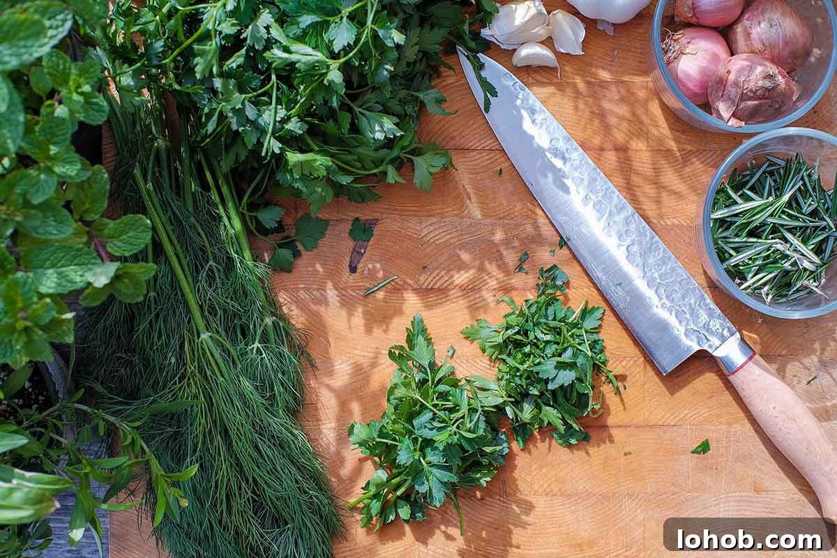 chopped fresh herbs with a knife on a cutting board