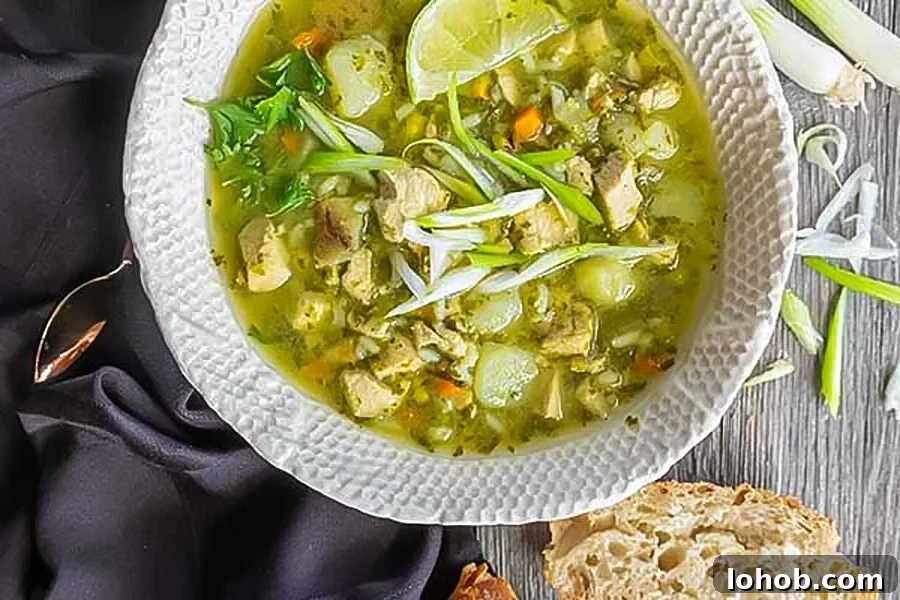 peruvian chicken soup in a bowl with crusty bread