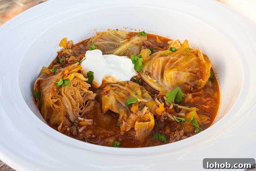 cabbage roll soup in a bowl topped with sour cream