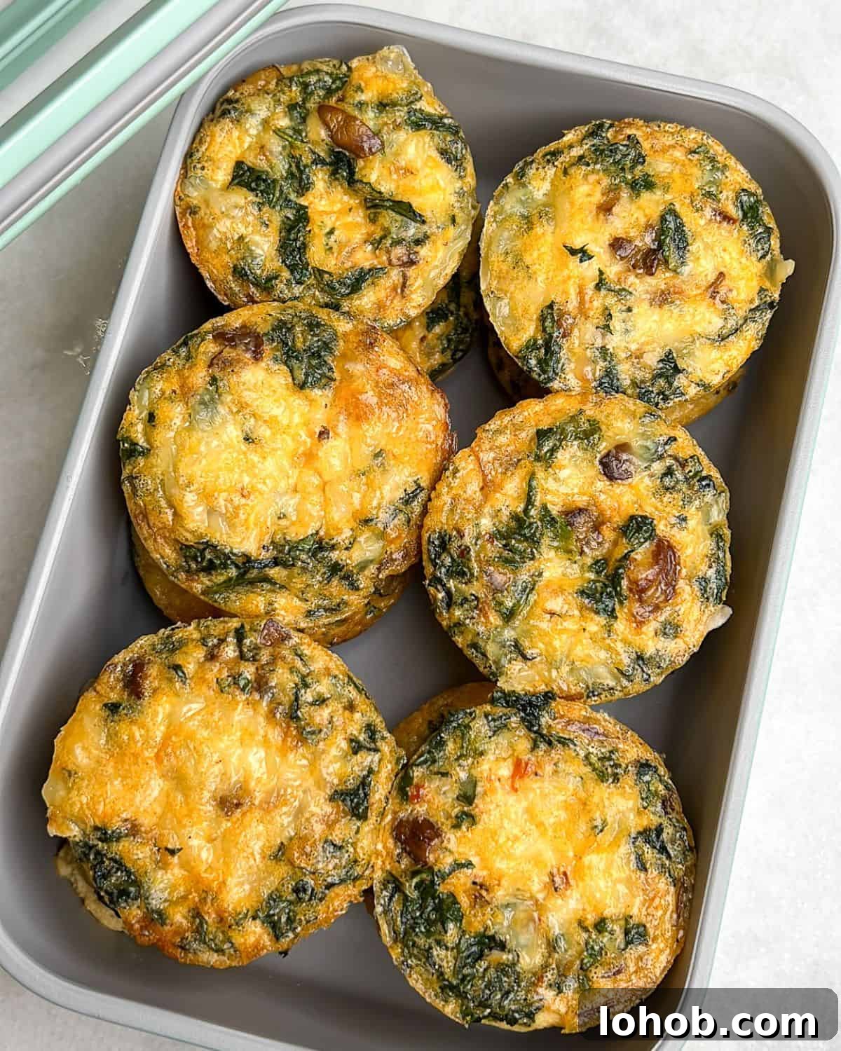 These kale and mushroom egg bites bring all the fluffy, protein-packed goodness of the Starbucks original, with a few flavor-packed upgrades! Kale and mushroom egg bites in a storage container.