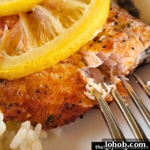 Grilled Salmon in Foil Packets with Lemon and Herbs 9 Grilled Salmon being peeled by a fork