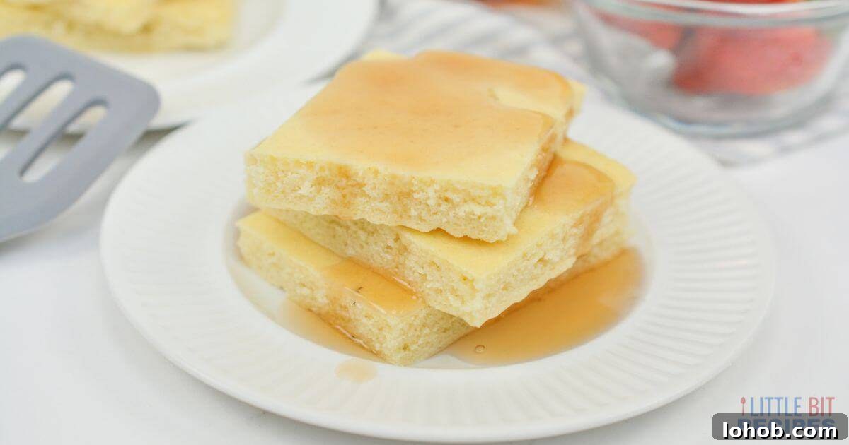 Sheet pan pancakes stack with syrup.