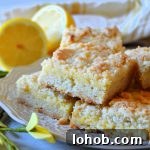 lemon crumble bars sitting on white plate