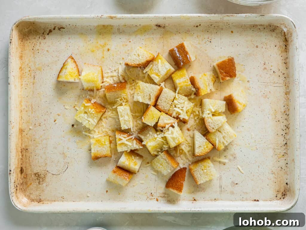 Grilled Shrimp Caesar Salad with Crispy Parmesan Croutons 7 Bread cubes coated with melted butter, oil and Parmesan on a baking sheet.