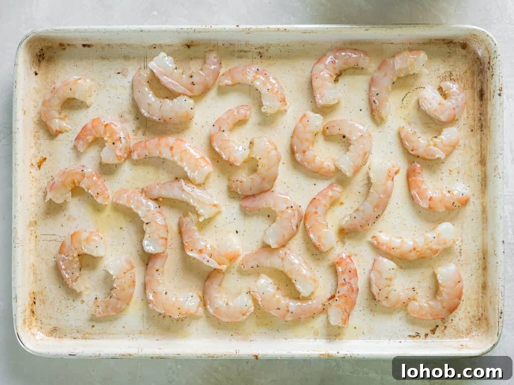 Grilled Shrimp Caesar Salad with Crispy Parmesan Croutons 10 Shrimp spread out over a baking sheet.