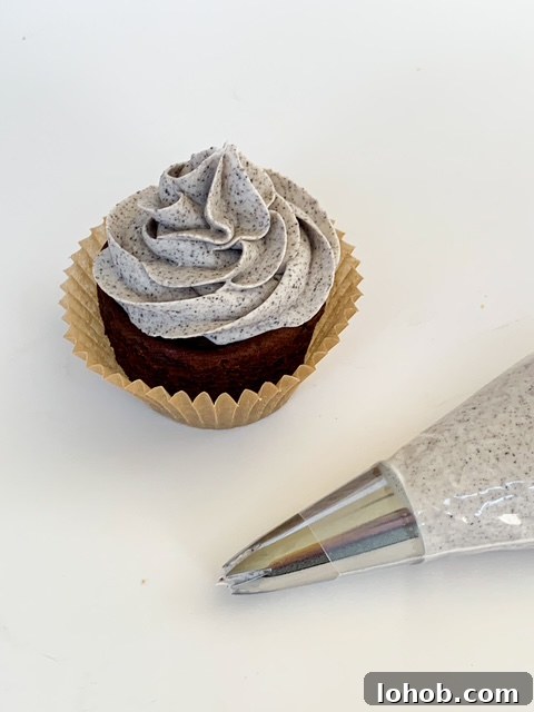 Cookies and Cream Stuffed Layer Cake Recipe 7 piping frosting onto cakes