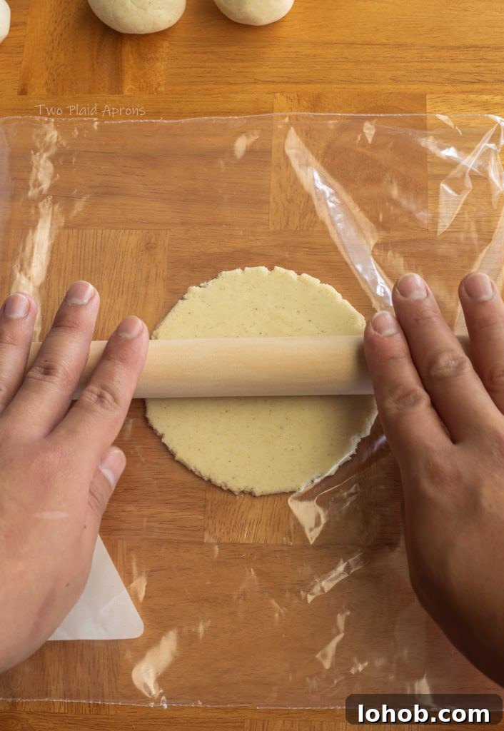 Homemade Corn Tortillas with 3 Simple Ingredients 6 Rolling the tortilla between a Ziploc bag with a rolling pin.