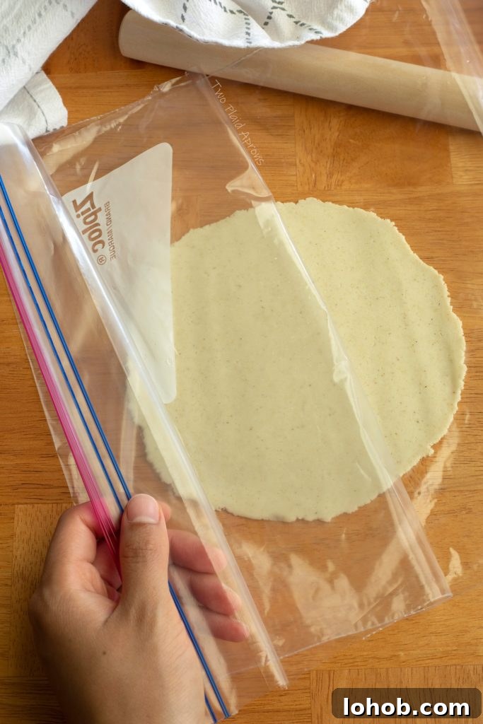 Homemade Corn Tortillas with 3 Simple Ingredients 7 Peeling the plastic sleeve away from a rolled out tortilla.