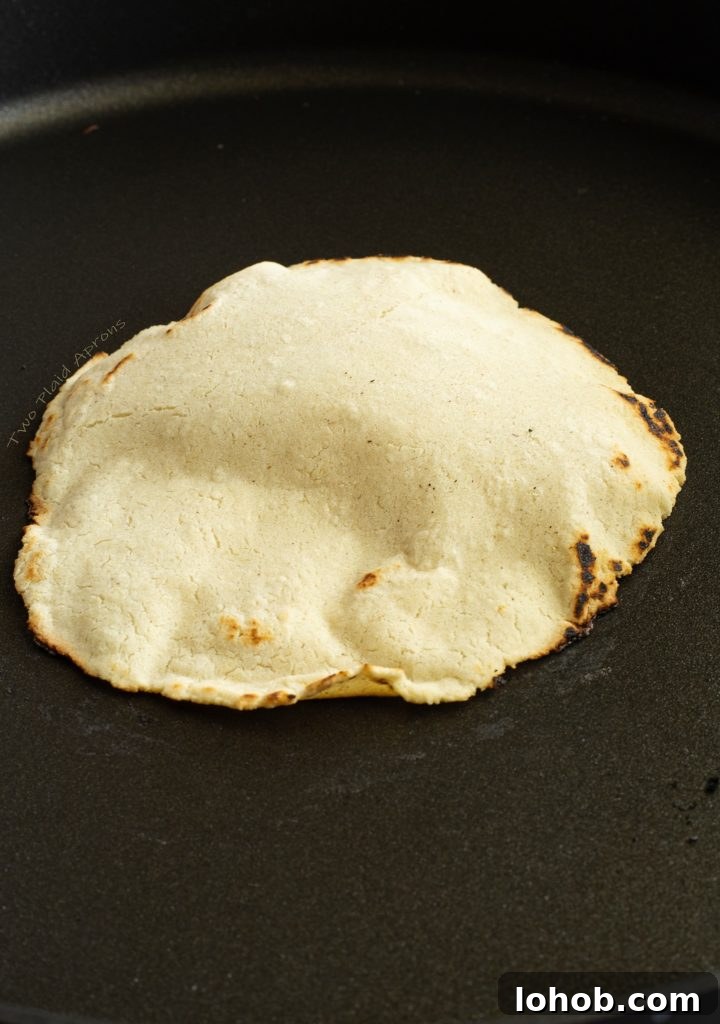 After flipping, the tortilla is starting to puff up.