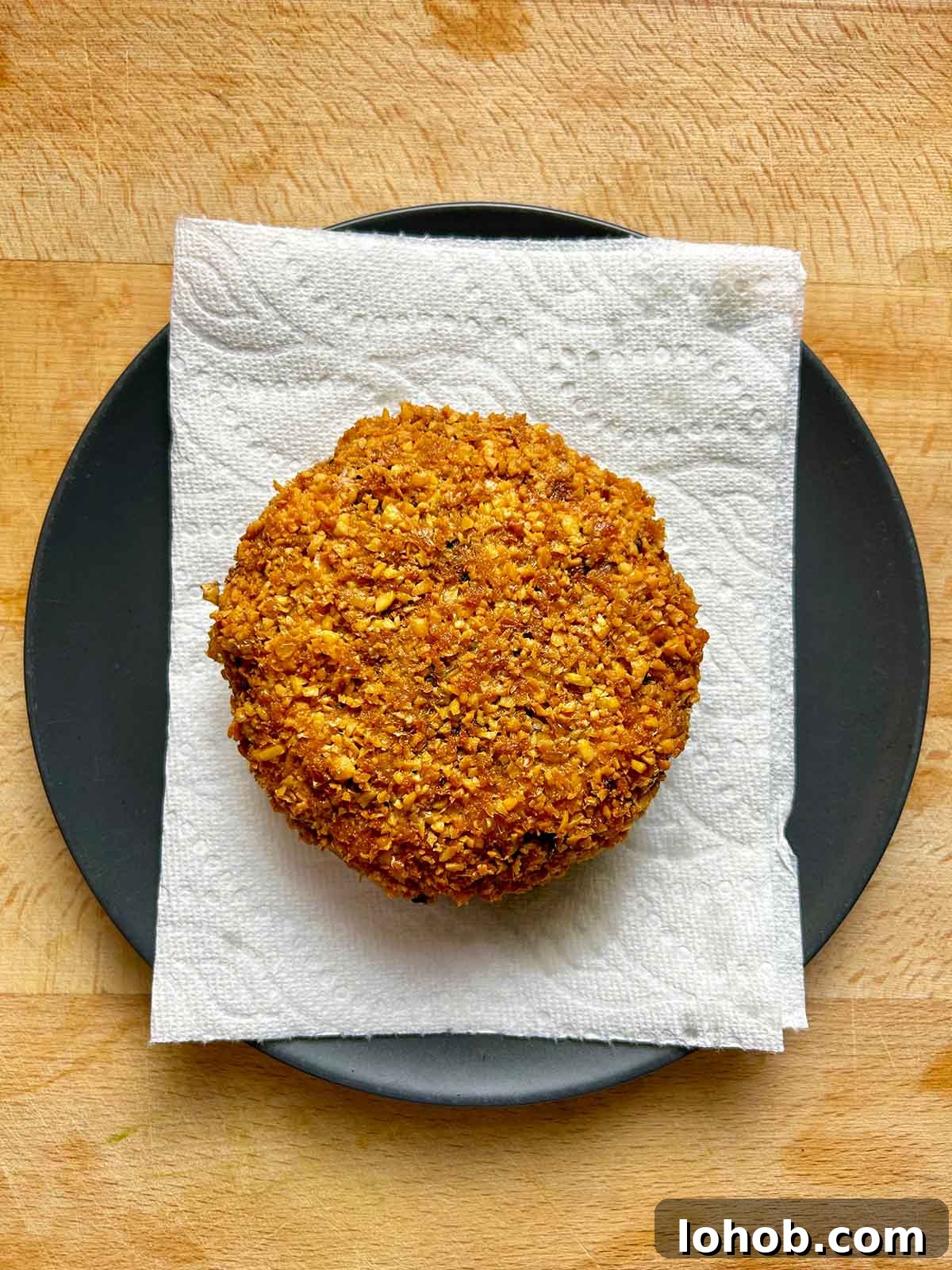 Chickpea-Crusted Black Bean Burger Recipe for Crispy Veggie Burgers 16 patty drying on paper towel lined plate