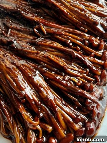 close up of black bean enoki mushrooms