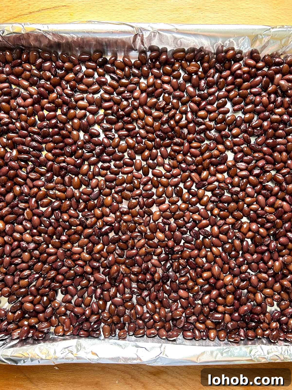 Chickpea-Crusted Black Bean Burger Recipe for Crispy Veggie Burgers 4 black beans in single layer on baking sheet
