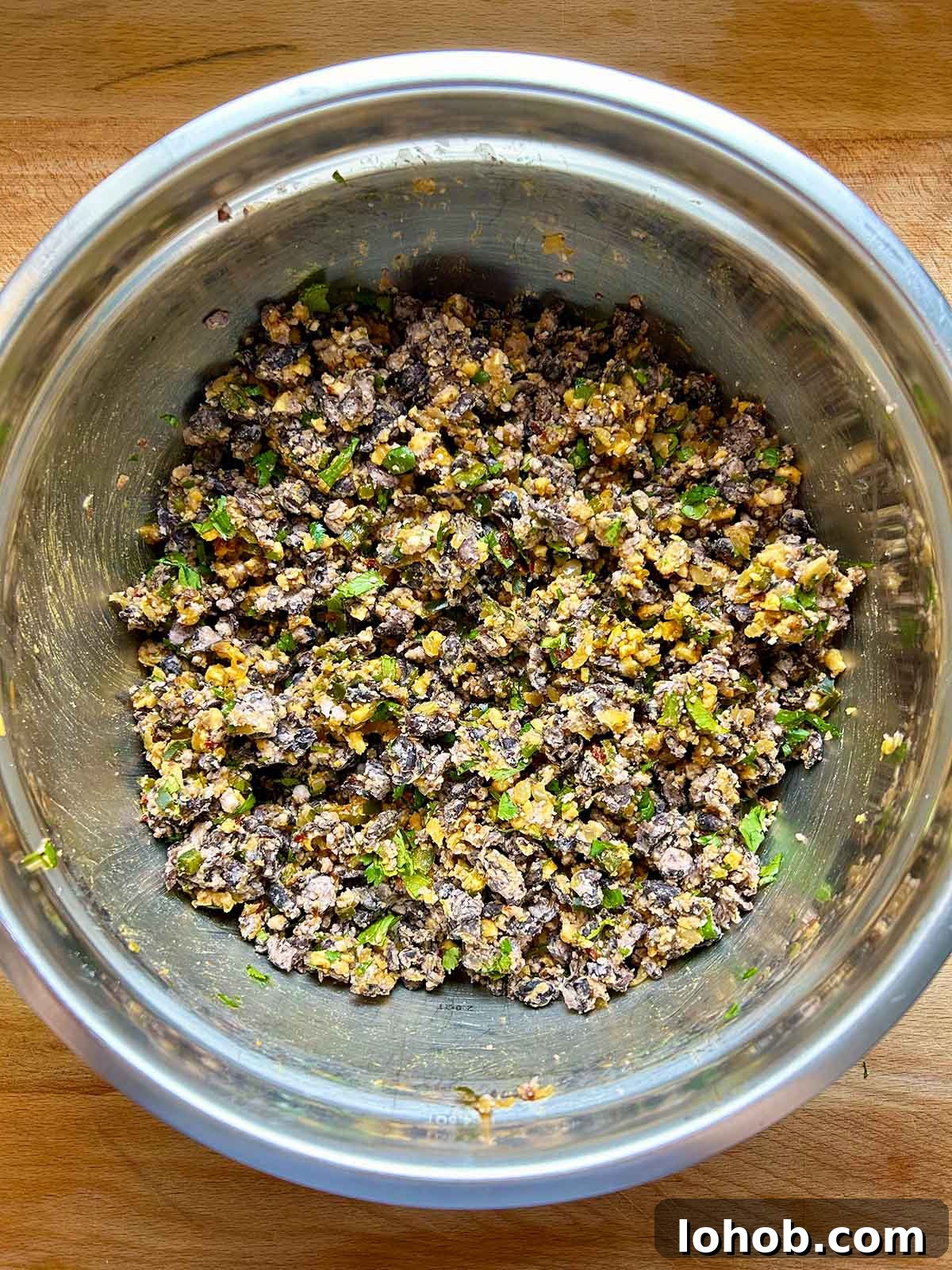 Chickpea-Crusted Black Bean Burger Recipe for Crispy Veggie Burgers 8 onion and black beans mixed in bowl