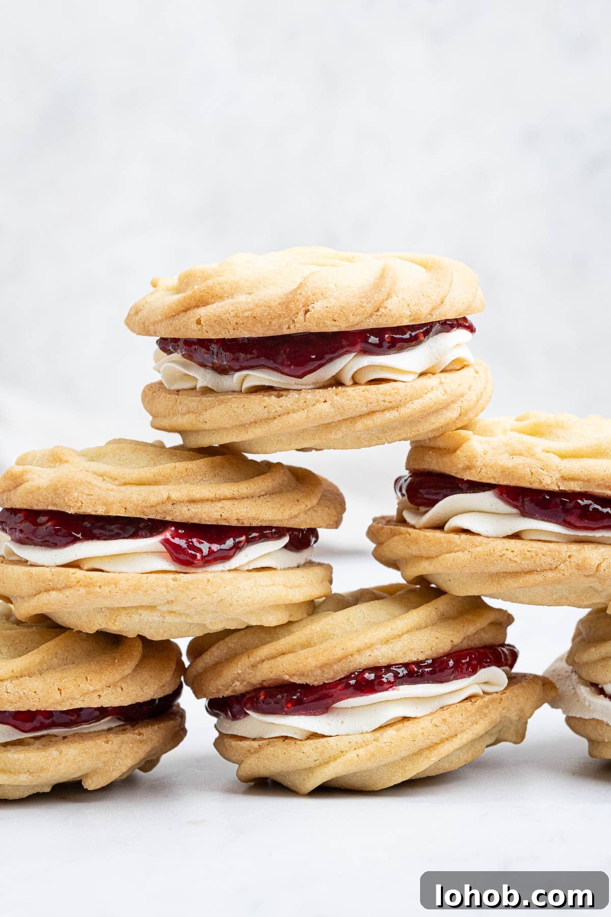 Vegan Viennese Whirls Recipe — Crisp, Buttery Cookies 2 A stack of vegan Viennese whirl biscuits.