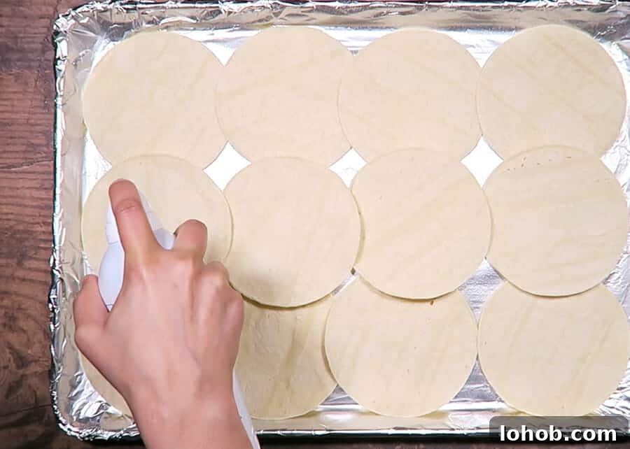 Crispy Baked Black Bean Tacos – Vegan Gluten-Free Recipe 11 spraying tortillas with cooking oil