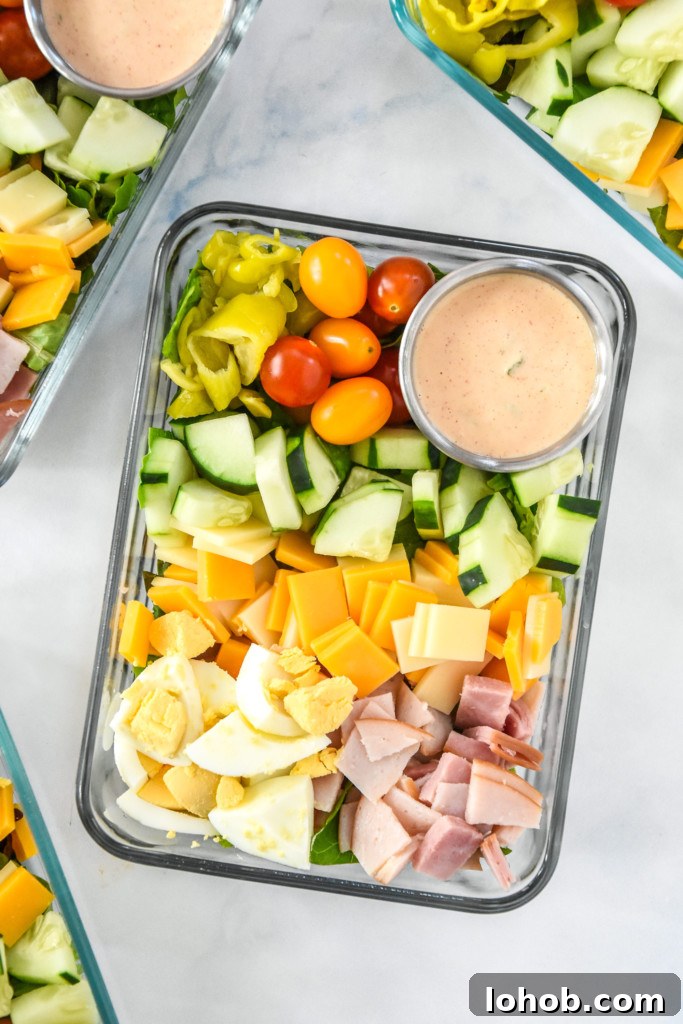 easy chef salad meal prep with dressing cup in a glass meal prep container.