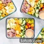 easy chef salad meal prep with dressing in rectangular glass containers.
