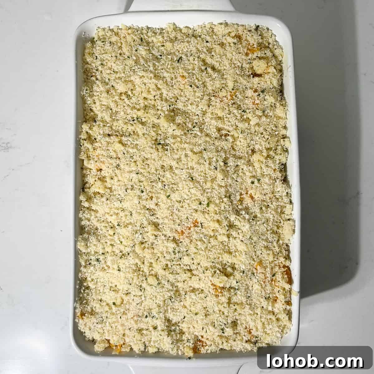 Creamy Baked Three-Cheese Macaroni with Garlic Parmesan Crumb Top 12 Three cheese baked macaroni and cheese in a large white oven dish, ready to go into the oven.