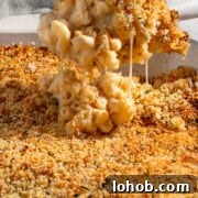 Creamy Baked Three-Cheese Macaroni with Garlic Parmesan Crumb Top 13 A scoop of baked three cheese mac and cheese with crispy garlic Parmesan crumb topping.