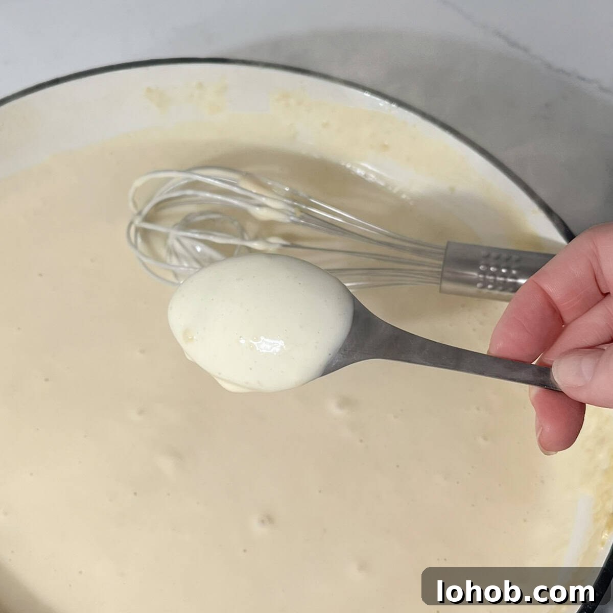Creamy Baked Three-Cheese Macaroni with Garlic Parmesan Crumb Top 6 White sauce coating the back of a tablespoon to show the consistency.