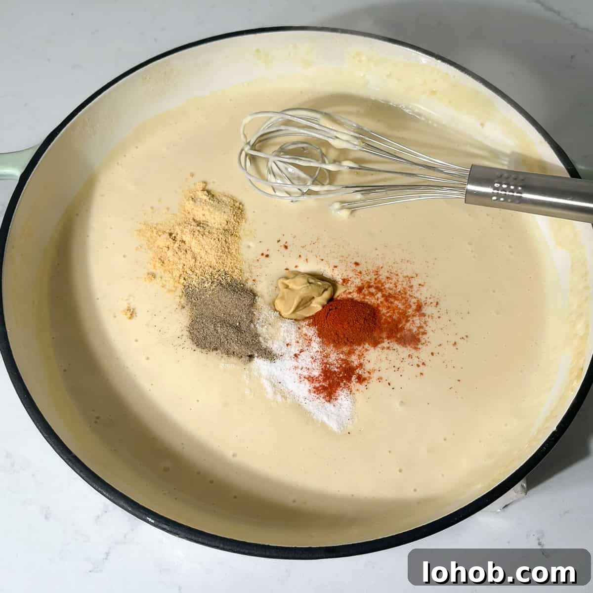 Creamy Baked Three-Cheese Macaroni with Garlic Parmesan Crumb Top 7 Adding the spices to the white sauce for the three cheese mac and cheese.