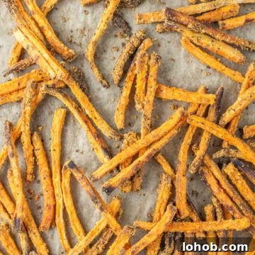 Crispy Oven-Baked Sweet Potato Fries Recipe 6 overhead shot of sweet potato fries on parchment-lined baking sheet