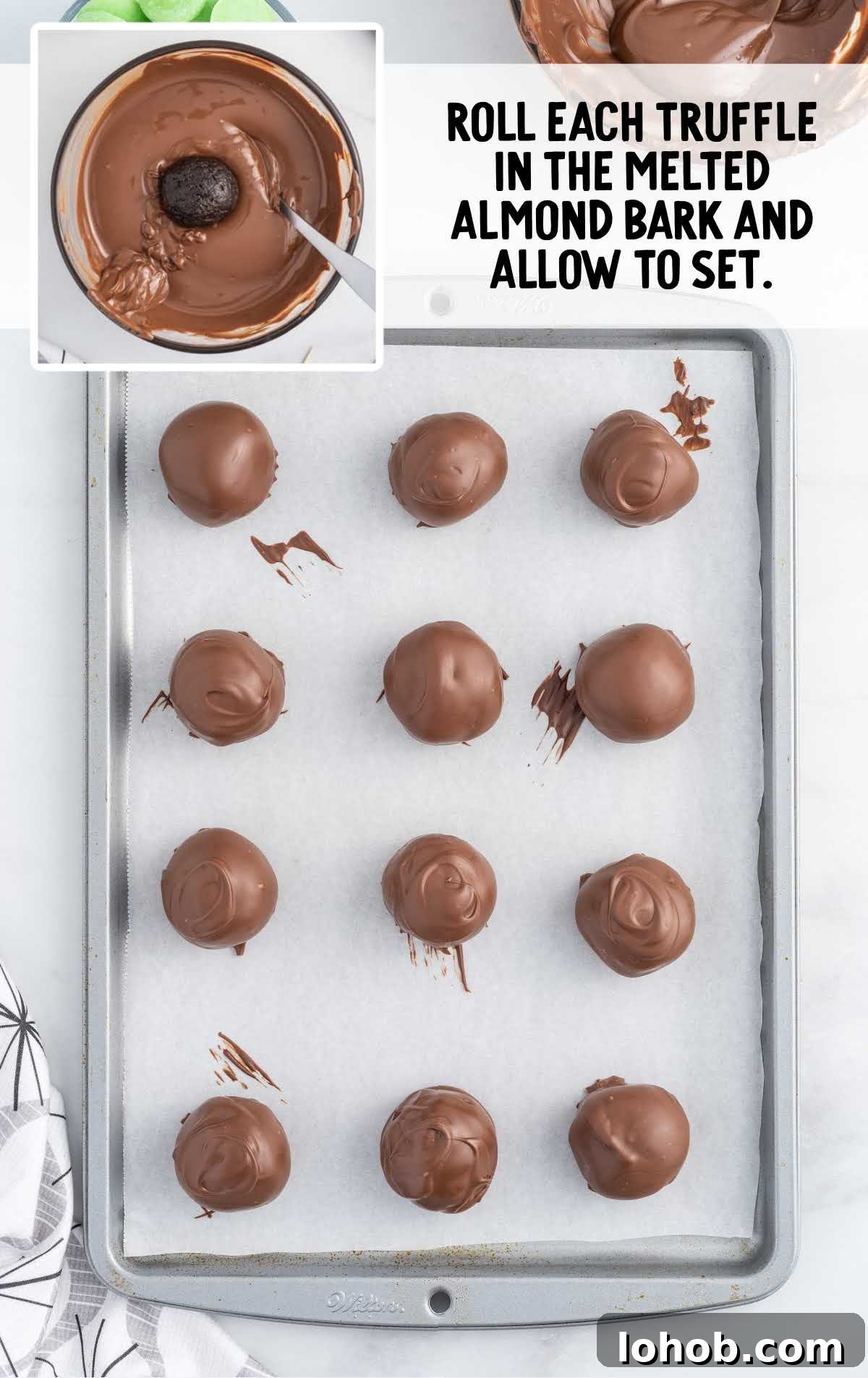 truffles rolled in the melted almond bark on a baking sheet