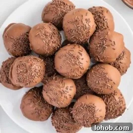 close up overhead shot of a plate of Nutella truffles topped with chocolate sprinkles