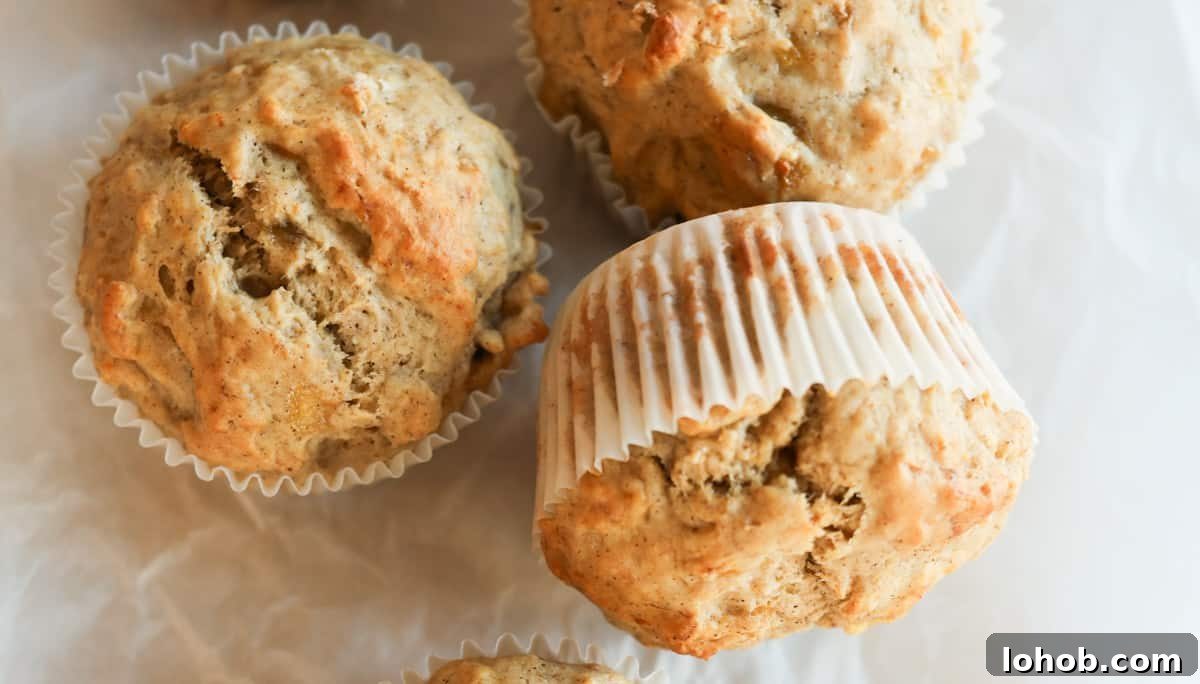 A group of banana bread muffins on parchment paper.