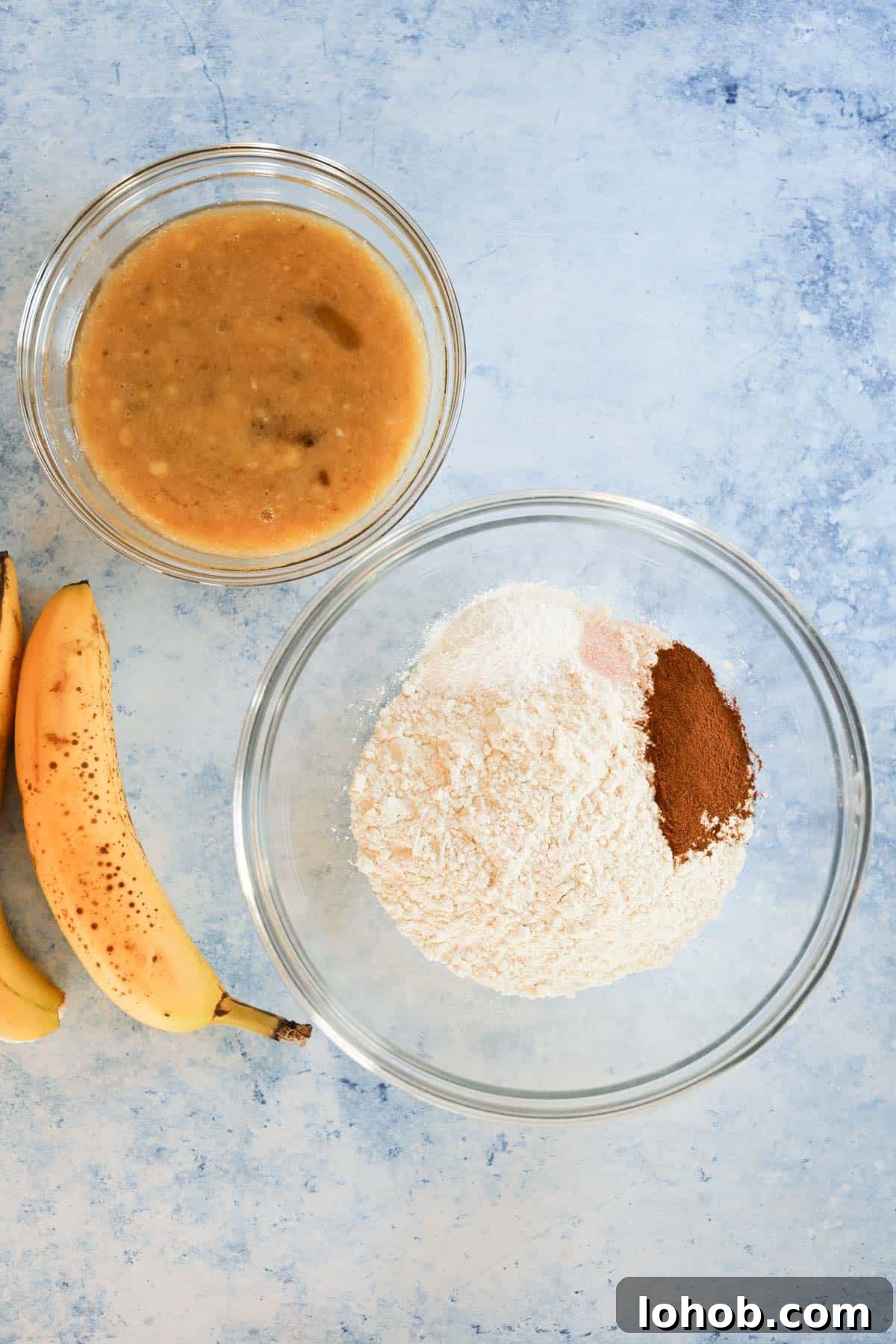 A bowl of bananas, flour, and sugar.