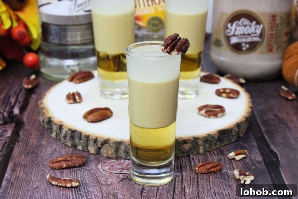 Pecan Pie Shot Recipe: Thanksgiving Vodka Shooter Guide 11 closeup of pecan pie shot with additional shooters in the background on a wooden stump