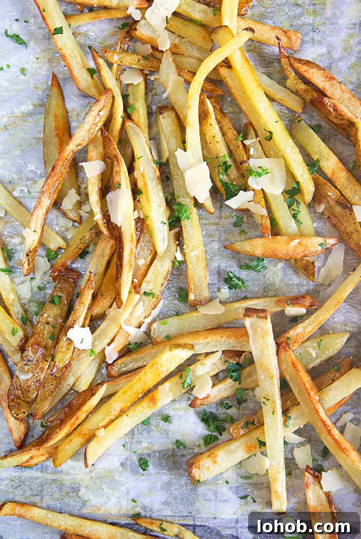Crispy Parmesan Truffle Fries Recipe with Garlic and Herbs 7 overhead shot of parmesan truffle fries on a baking sheet