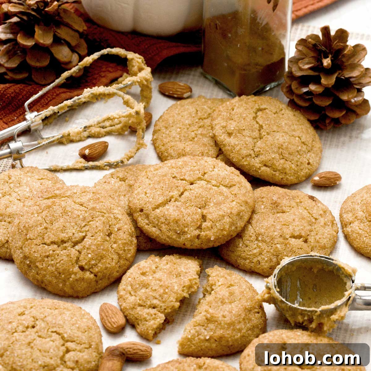 Gluten-Free Peanut Butter and Jelly Thumbprint Cookies 11 Gluten-Free pumpkin snickerdoodle cookies with almond flour and cinnamon stacked on parchment paper.
