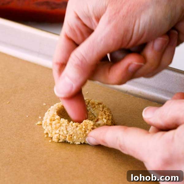 Gluten-Free Peanut Butter and Jelly Thumbprint Cookies 8 Shaping the well inside of the peanut butter cookie with your fingertips.