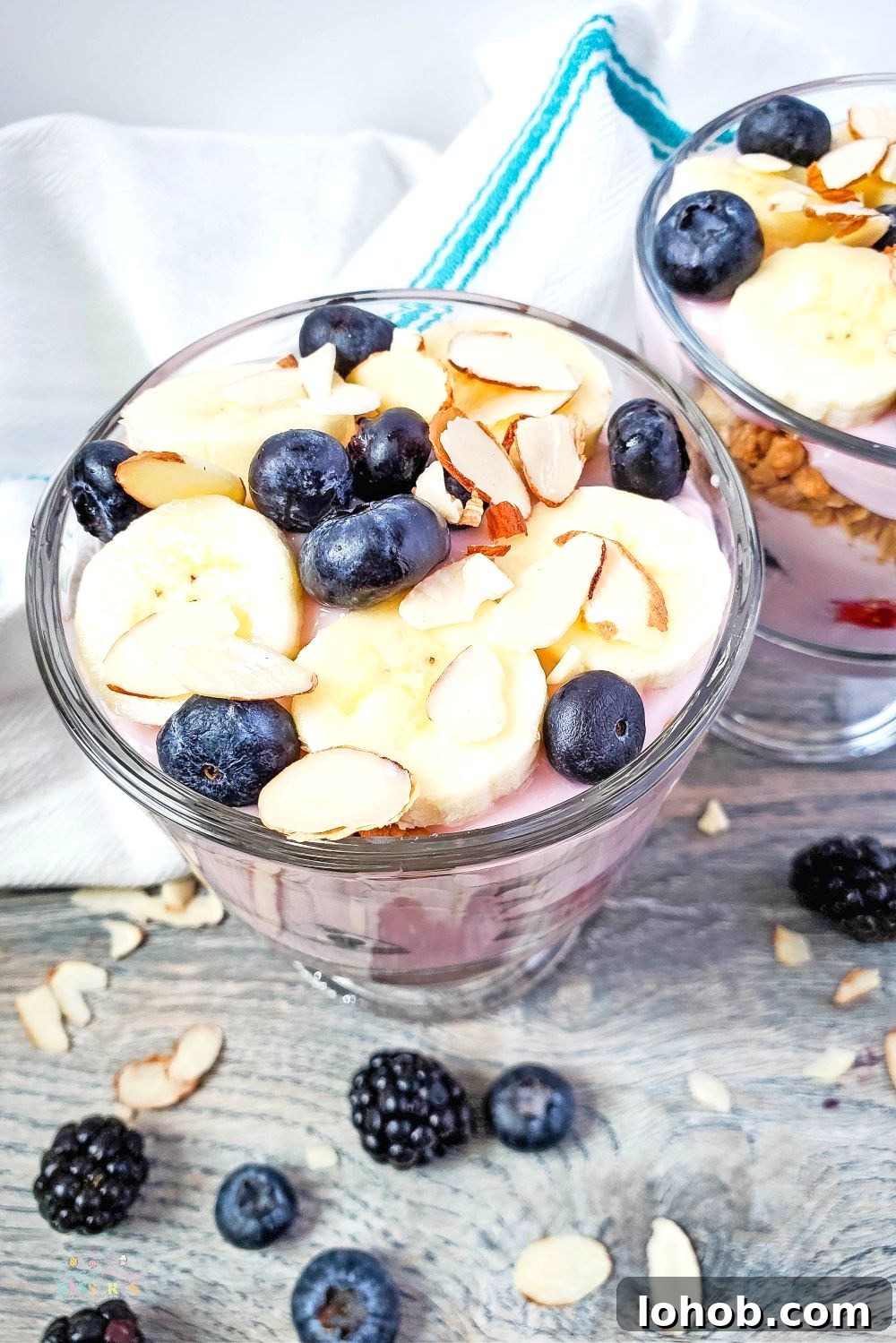 Berry Yogurt and Banana Trifle Recipe — Layered Summer Dessert 4 Angle image of triple berry trifle in a cup