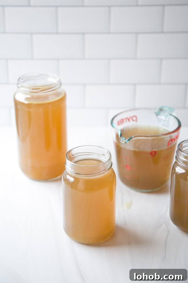 Gut-Healing Low FODMAP Chicken Stock Recipe (Gluten-Free) 8 Gut-Healing Low FODMAP Chicken Stock Recipe for Soup in jars and cup measures