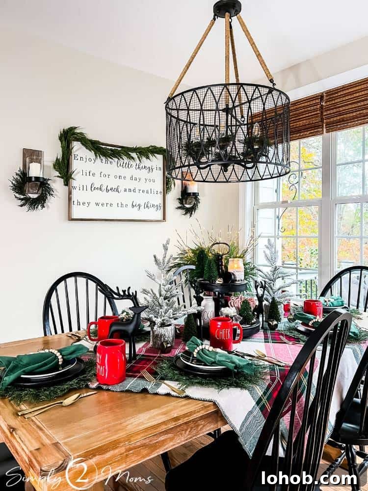 table set for holiday meal with greenery and plaid Christmas decor