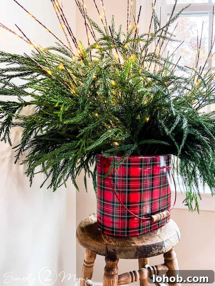fresh cut greenery in plaid bucket with faux sticks with LED lights